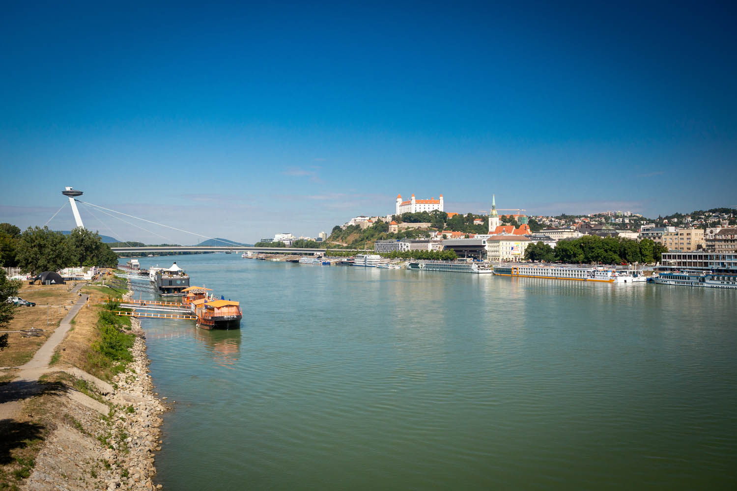 Uitzicht over Bratislava vanaf de brug met de Donau en het kasteel