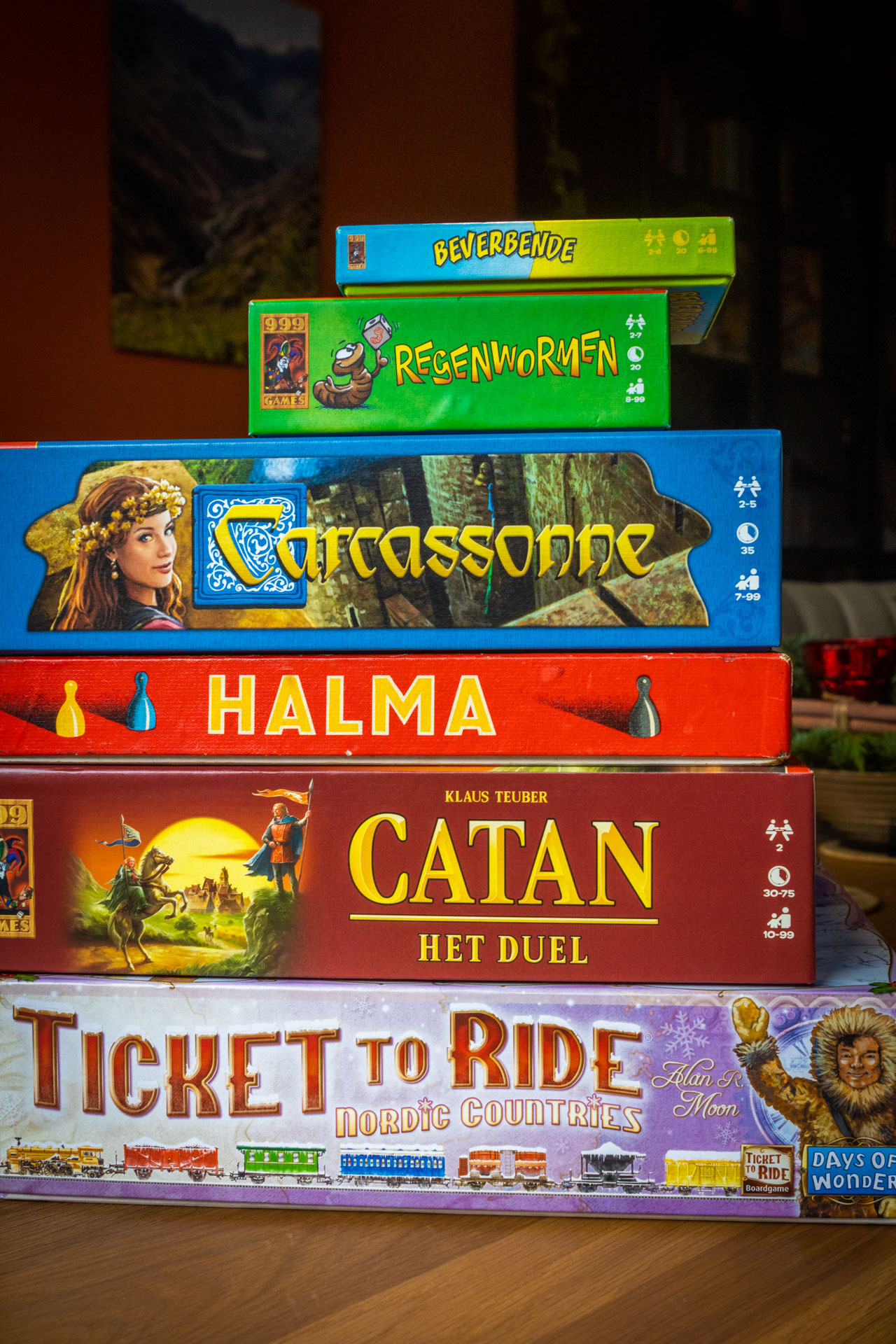 Stapel met leuke spellen voor volwassenen: Beverbende, Regenwormen, Carcassonne Halma, Catan, Ticket to Ride Nordics